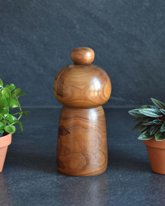 Kazuo Takamizawa kokeshi doll showing the smooth rounded side and rich grain pattern