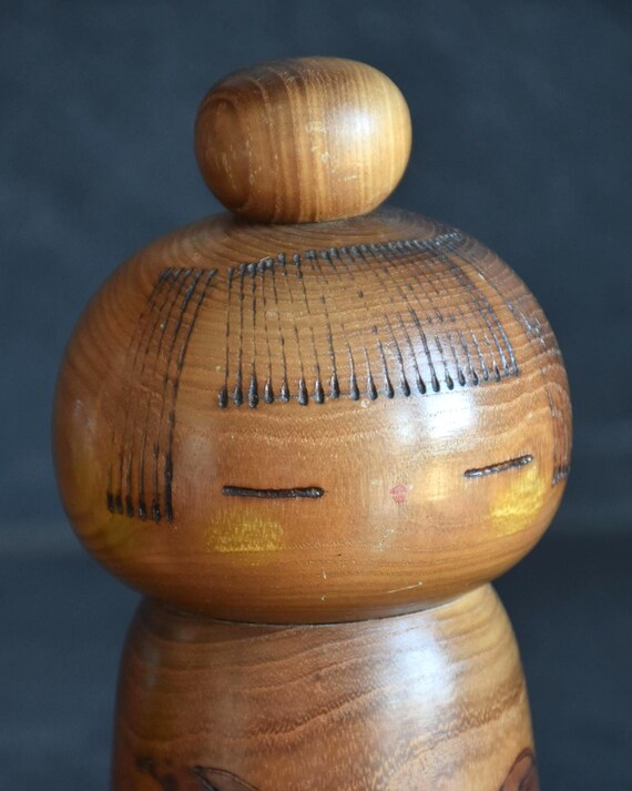 Kazuo Takamizawa kokeshi doll close up of the carved hair lines and facial features