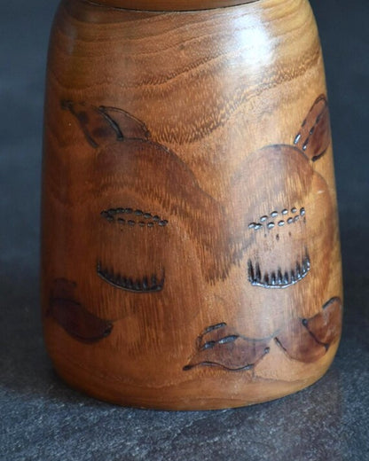 Kazuo Takamizawa kokeshi doll pattern detail showing wood-burned winter camellia blossoms