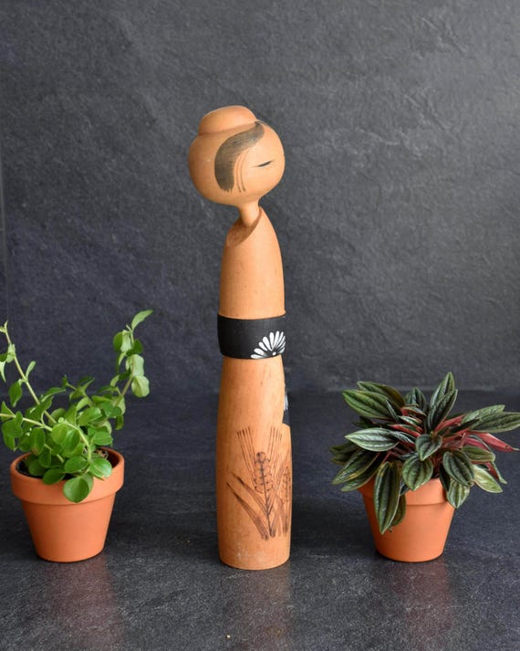 Sato Suigai Minatsuki Kokeshi Doll angled front view showcasing the wood grain and obi