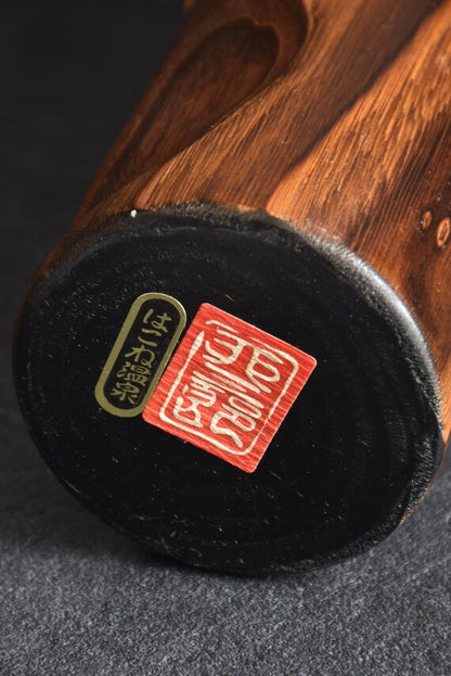 Usaburo Mori Kan Kokeshi Doll base showing workshop labels and stamps