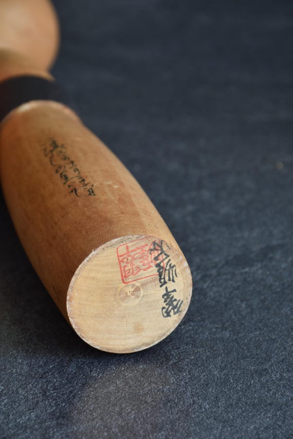 Sato Suigai kokeshi base with artisan signature and red stamp mark