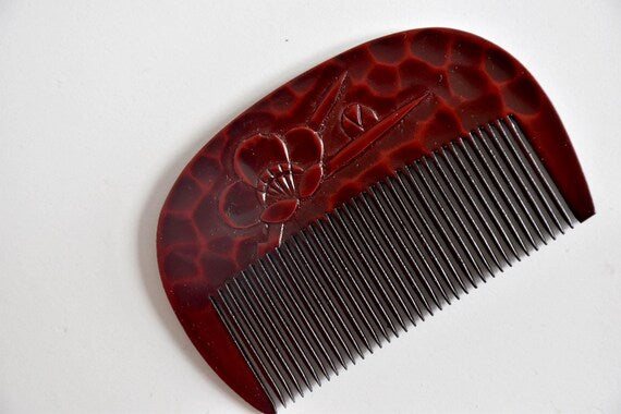 Kamakura-Bori Plum Blossom Comb angled view highlighting textured lacquer finish
