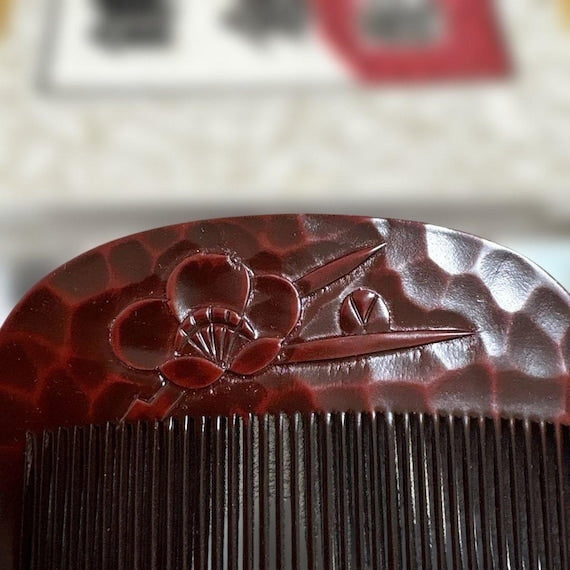 Kamakura-Bori Plum Blossom Comb close up of the carved plum blossom motif