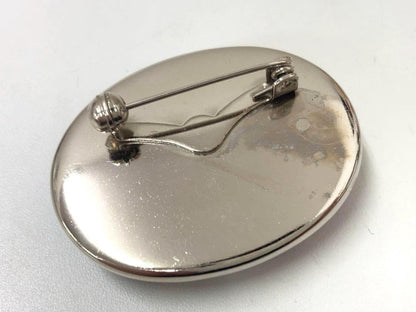 Kutani Ware ceramic brooch showing the metallic back and secure pin fastening