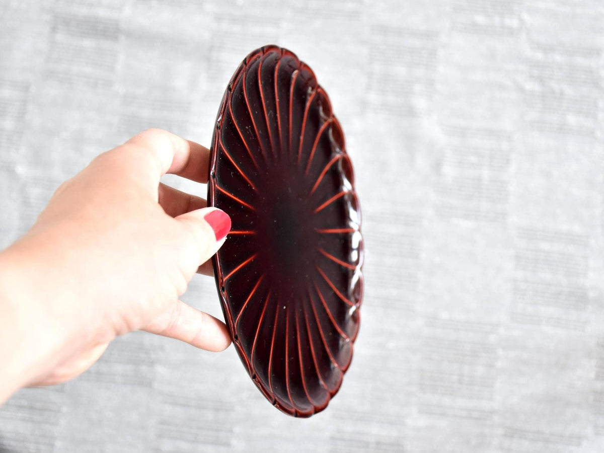 Chrysanthemum Kiku-Zara Urushi Lacquer Plate held next to a hand to demonstrate size