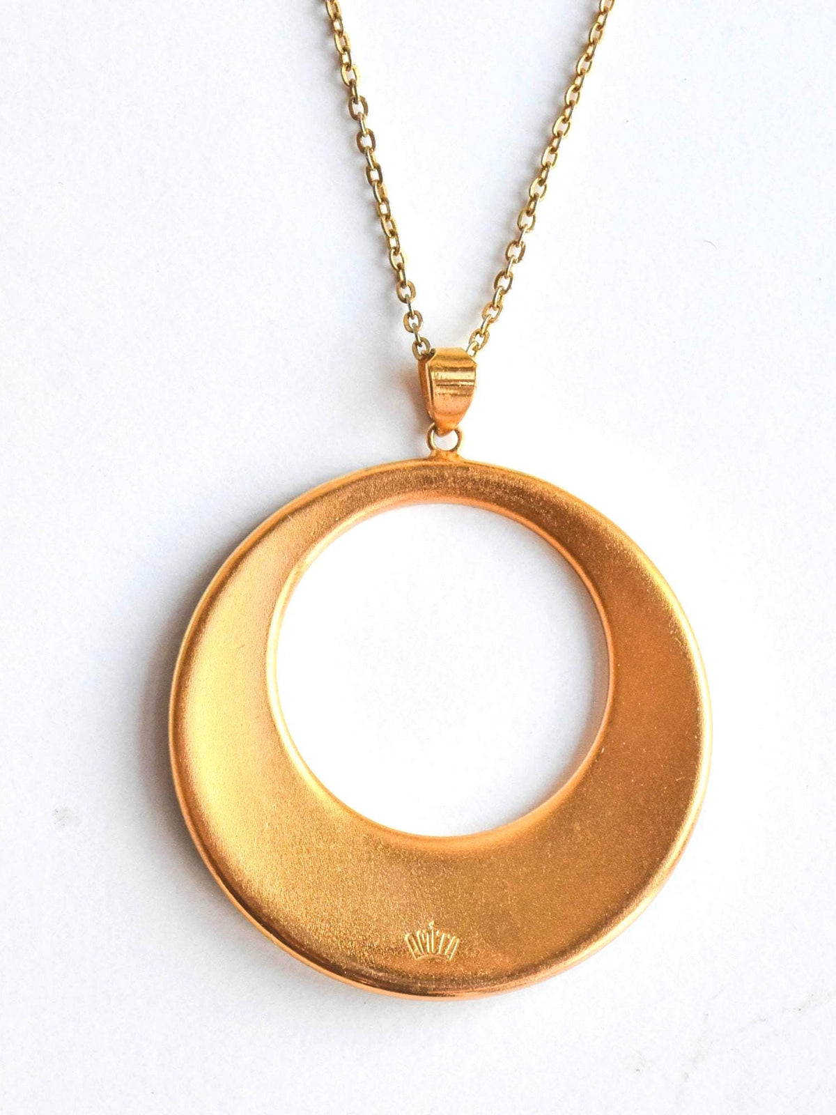 Amita Damascene Pendant Necklace Bamboo Grove showing the matte gold-tone back and signature