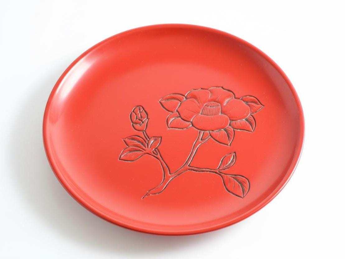 Murakami Kibori Tsuishu Camellia Red Lacquer Plate angled view showing the circular serving tray profile