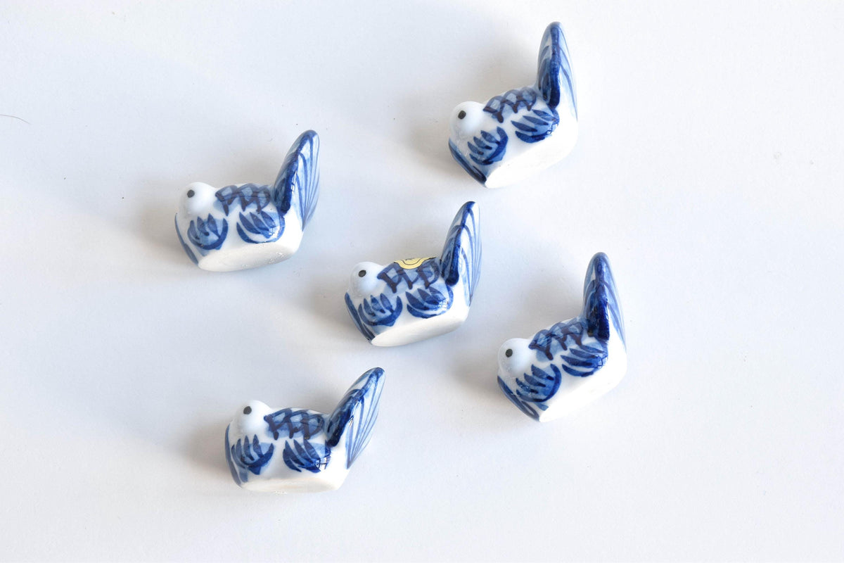 Arita-Yaki porcelain goldfish chopstick rest set arranged in a top-down view showing blue and white patterns