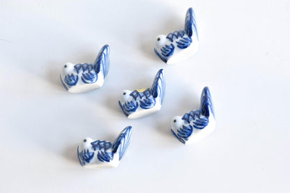 Arita-Yaki porcelain goldfish chopstick rest set arranged in a top-down view showing blue and white patterns