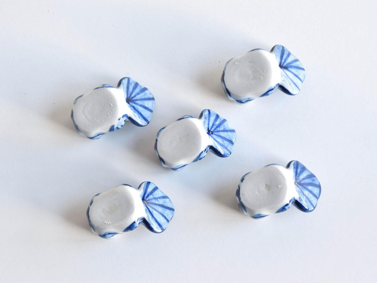 Arita-Yaki porcelain goldfish chopstick rest set shown underside up displaying the smooth glazed bases of all five
