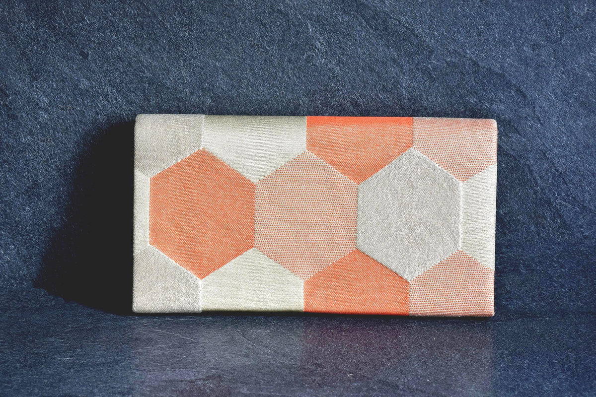 Nishiki Weave Geometric Obi Clutch Bag showing the back view and soft color tones