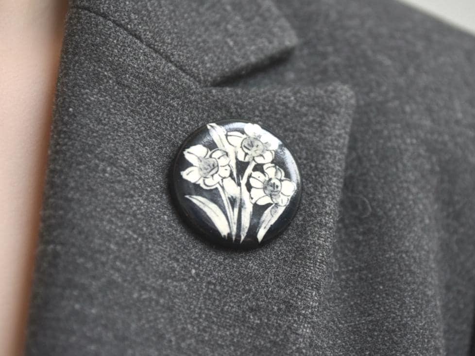 Kiyomizu Porcelain Brooch Narcissus Motif pinned to a gray textured blazer