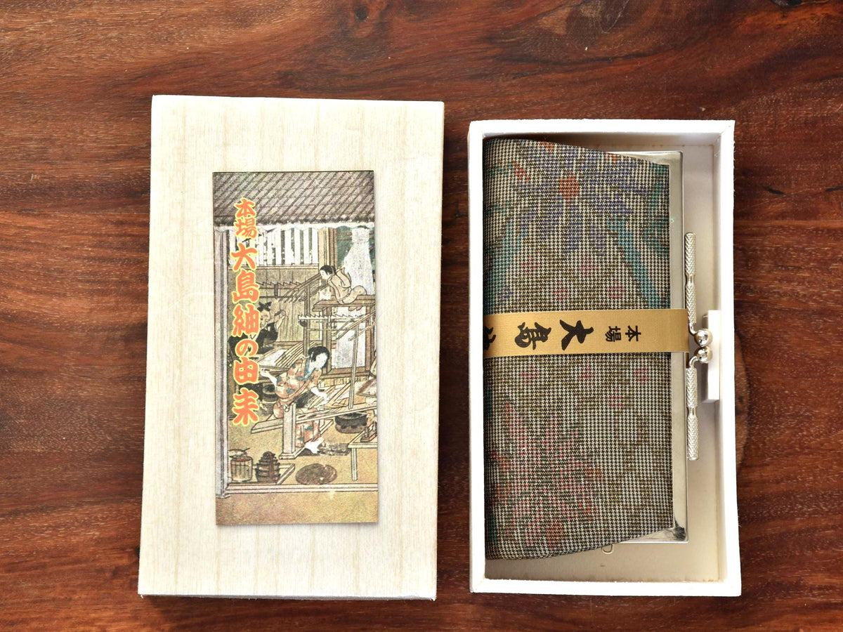 Oshima Tsumugi Silk Gamaguchi Coin Purse Brown shown inside presentation box