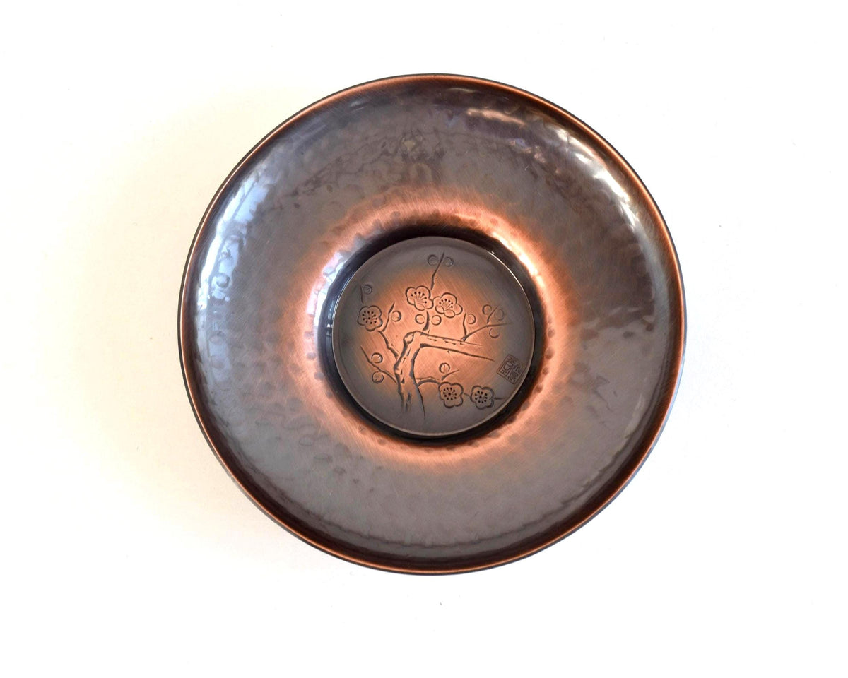 Shochikubai Hammered Copper Chataku Tea Set saucer adorned with a blossoming plum branch engraving