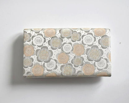 Nishijin-Ori silk clutch back view showing the continuous plum blossom brocade pattern