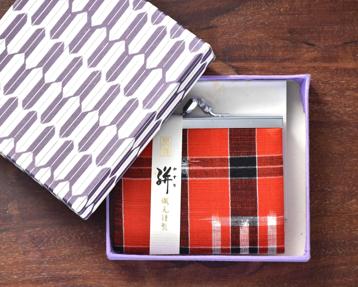 Kasuri Fabric Gama-Guchi Wallet nestled inside open purple patterned gift box on wood