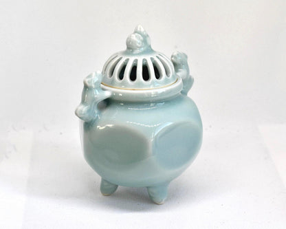 Nabeshima celadon incense burner angled view highlighting the hexagonal body and celadon glaze