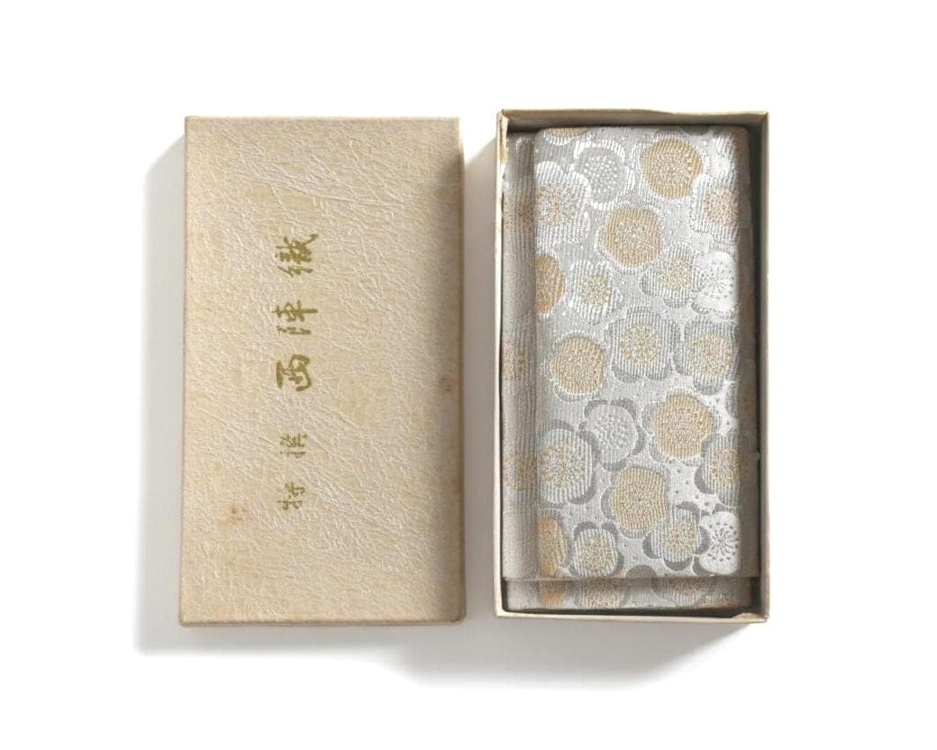 Nishijin-Ori Silk Brocade Clutch Plum Blossom Motif in a storage box with Japanese text on the lid
