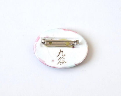 Kutani-Yaki ceramic brooch back showing the secure metal pin clasp and handwritten Kutani signature
