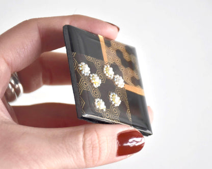 Japanese Wood Brooch Kikkō Pattern Lacquer Pin angled view highlighting the glossy transparent lacquer coating and surface