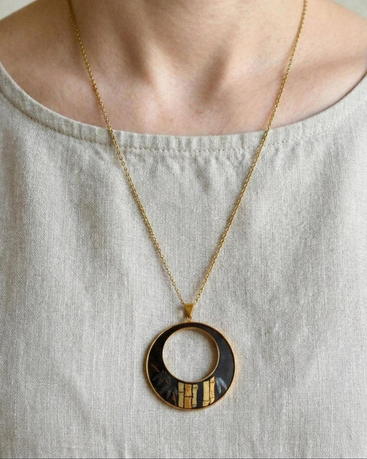 Amita Damascene Pendant Necklace Bamboo Grove worn against a light linen top