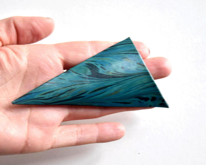 Japanese Marbled Blue Leather Triangular Brooch held in an open hand to show scale