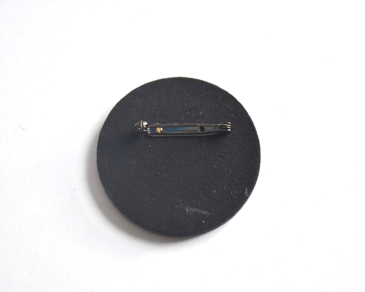 Japanese lacquerware floral brooch showing the black back and metal pin clasp