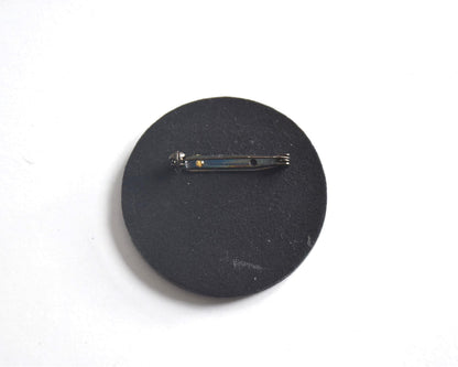 Japanese lacquerware floral brooch showing the black back and metal pin clasp
