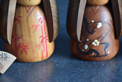 Daisuke Takeda kokeshi set featuring bamboo and plum blossom patterns