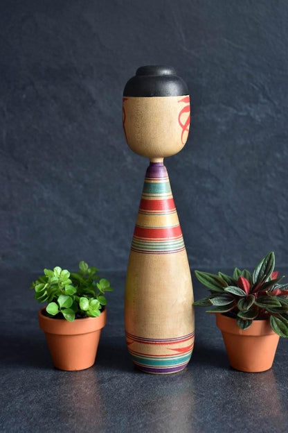 Zenji Sato Tsugaru kokeshi doll showing back view with painted red motifs