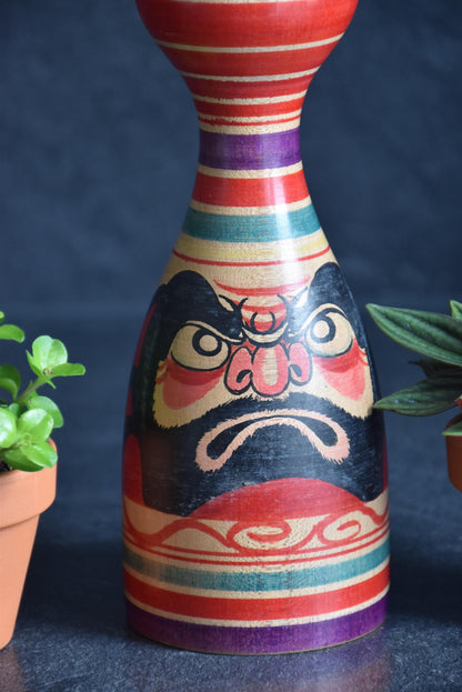 Senzo Mori Tsugaru kokeshi doll close up of the red peony motif on the body