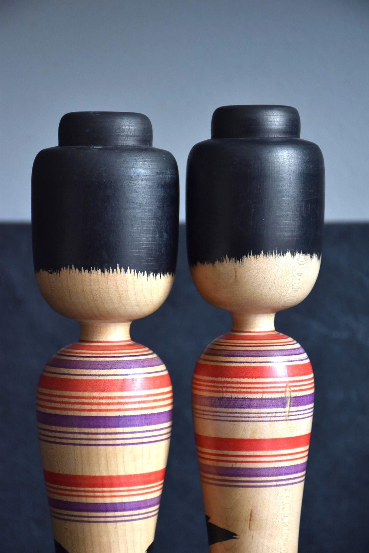 Zenji Sato kokeshi pair showing details of the black hair and upper body