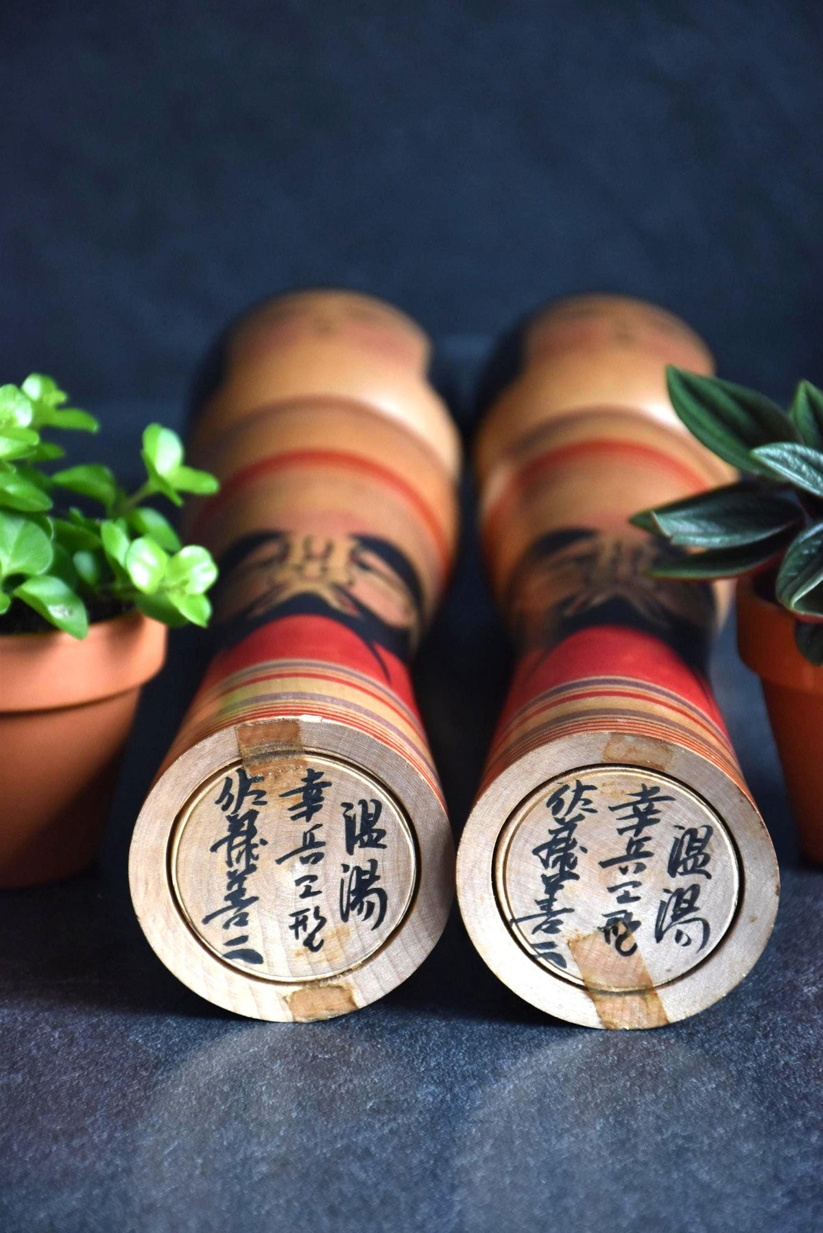 Zenji Sato kokeshi dolls showing the base with handwritten artist signatures