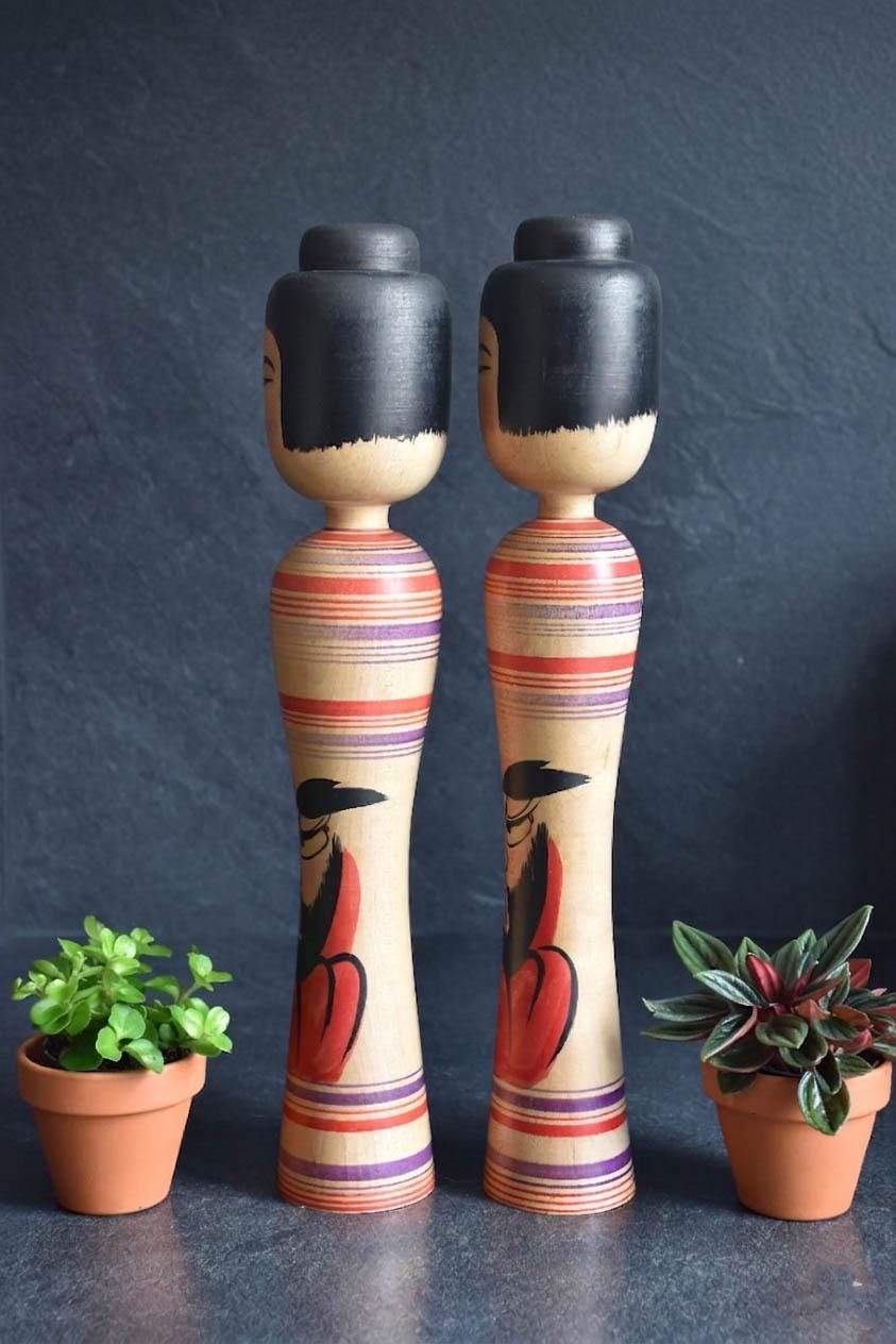 Zenji Sato kokeshi pair showcasing side profile and body details