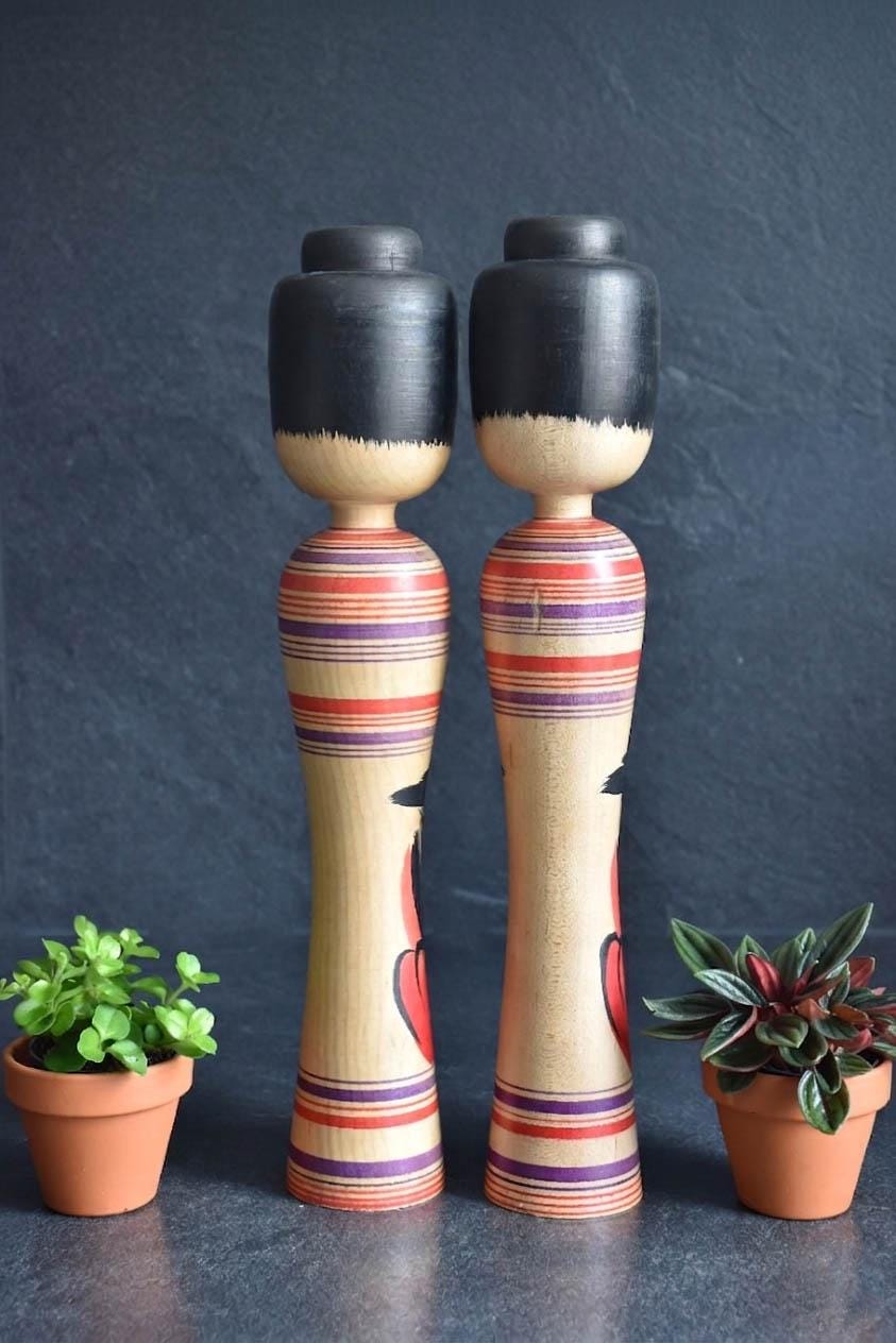 Zenji Sato kokeshi dolls showing the reverse view with striped patterns