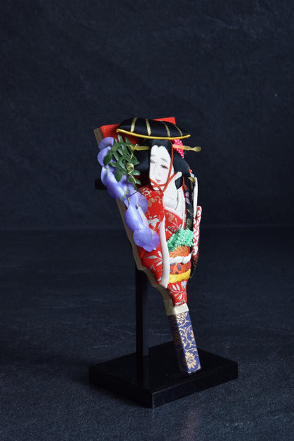 Hagoita Battledore With Kimono Doll And Bamboo Motif angled view on its black stand highlighting the textile doll face and