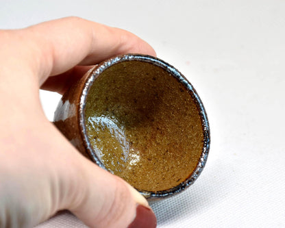 Karatsu ware guinomi sake cup, inside of the ceramic cup held in a hand