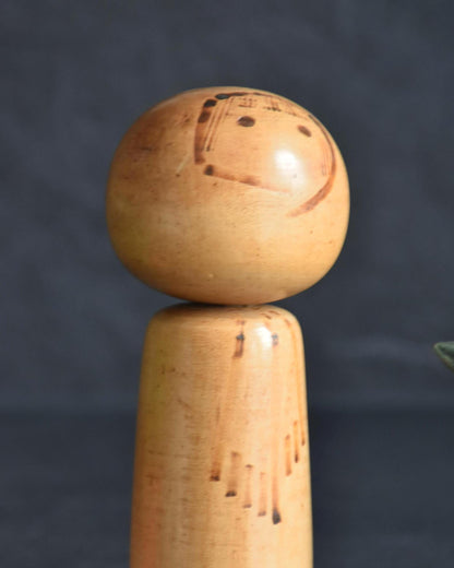 Kenichi Murakami kokeshi doll close up of the head with pyrography facial details