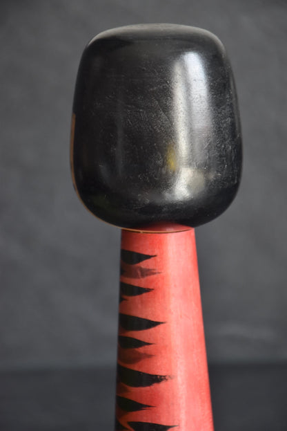 Hideo Ishihara kokeshi doll, pattern detail showing rhythmic black brushstrokes on red base