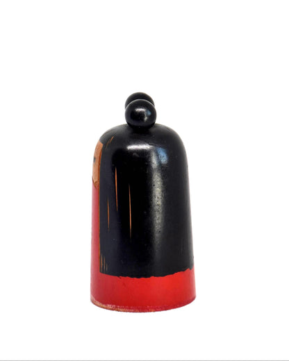 Japanese Kokeshi Doll With Black Ribbon showing the profile view from the other side