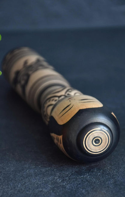 Zenji Sato kokeshi doll showing the top head and concentric circles