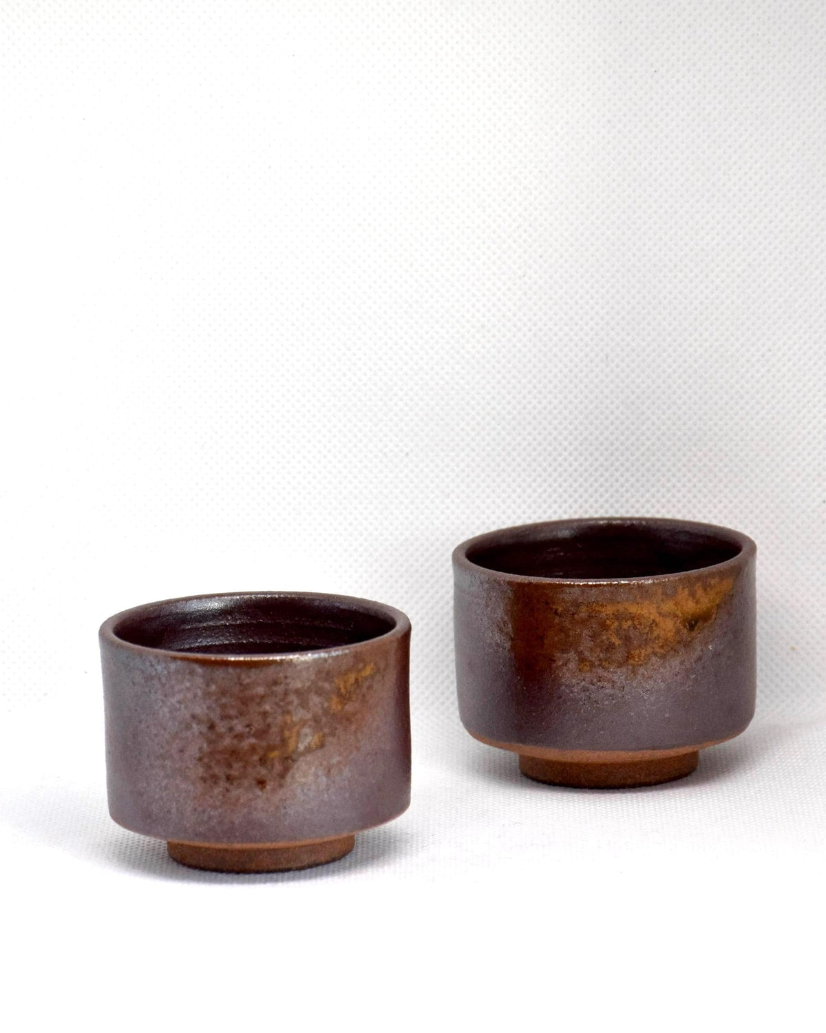 Tanba-yaki sake cups brown glaze set slight angle view highlighting the earthy tones