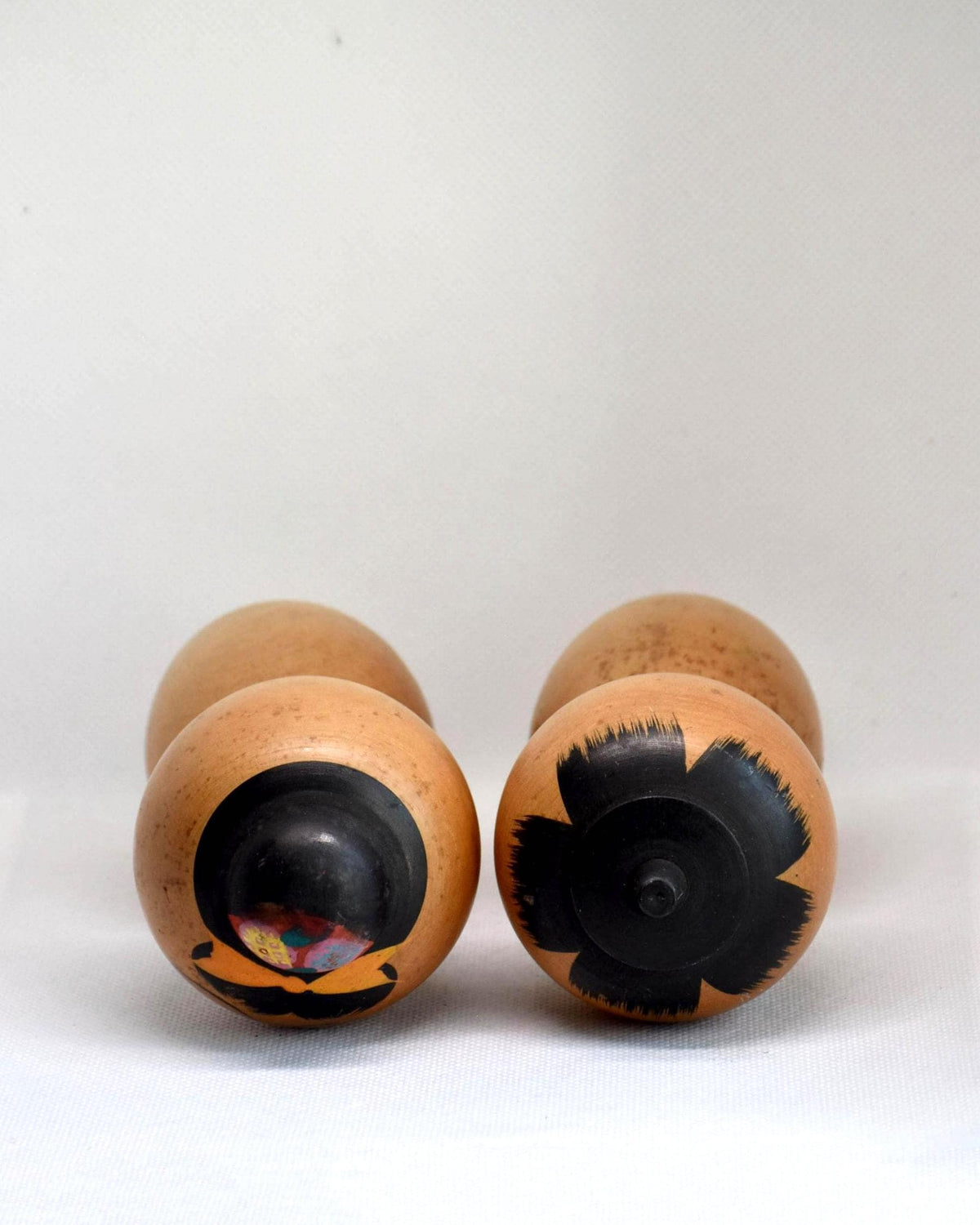 Hand-Painted Calligraphy Kokeshi Doll Pair top view of the crown patterns and hair details.