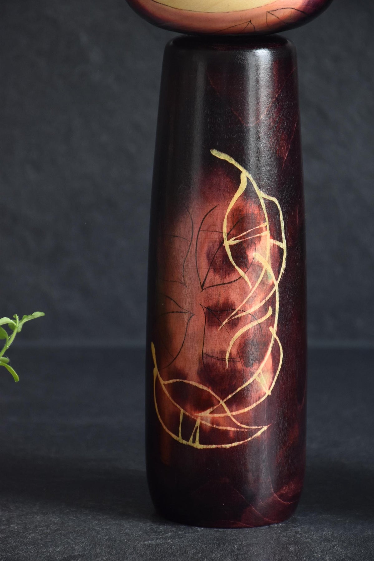 Masami Kato kokeshi doll body close up showing the outlined autumn leaves design