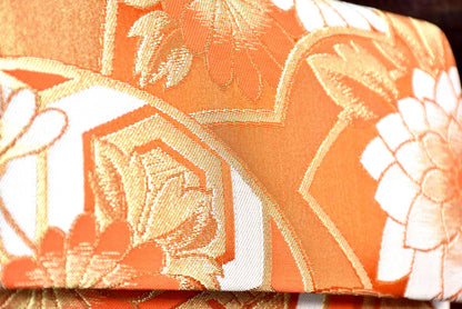 Saga Nishiki brocade clutch handbag detailed view of the shimmering gold and white floral brocade pattern.