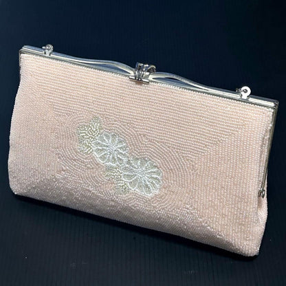 Japanese beaded clutch back showing pale cream and rose seed bead flower pattern
