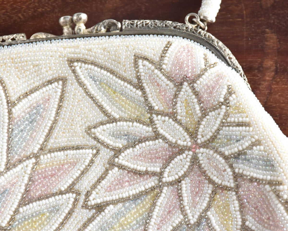 Vintage Japanese beaded clutch handbag close up of the detailed floral pattern made of tiny glass beads