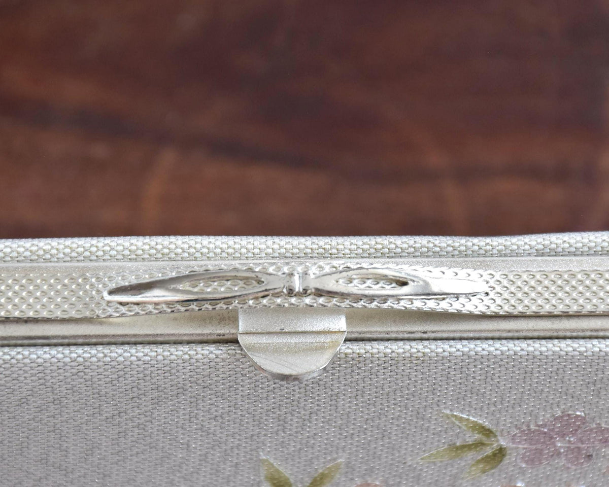 Japanese Floral Clutch With Raised Metallic Cord Detail close up of the decorative clasp closure