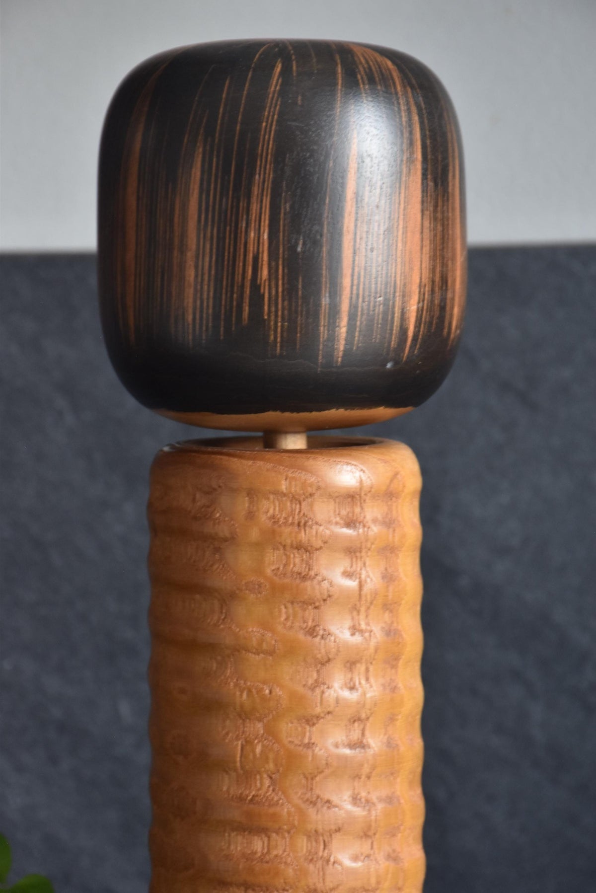 Usaburo Sosaku Kokeshi doll close-up of the head and shoulders showing the neck joint